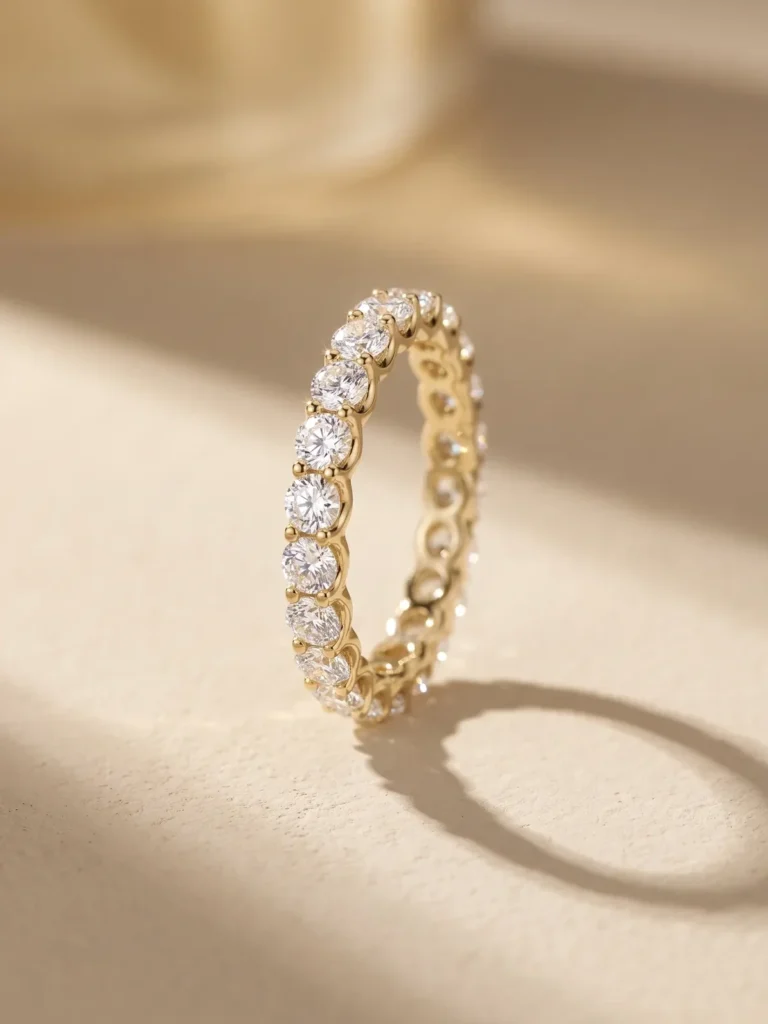 Full-eternity round diamond gold band ring in warm sunlight with soft shadow