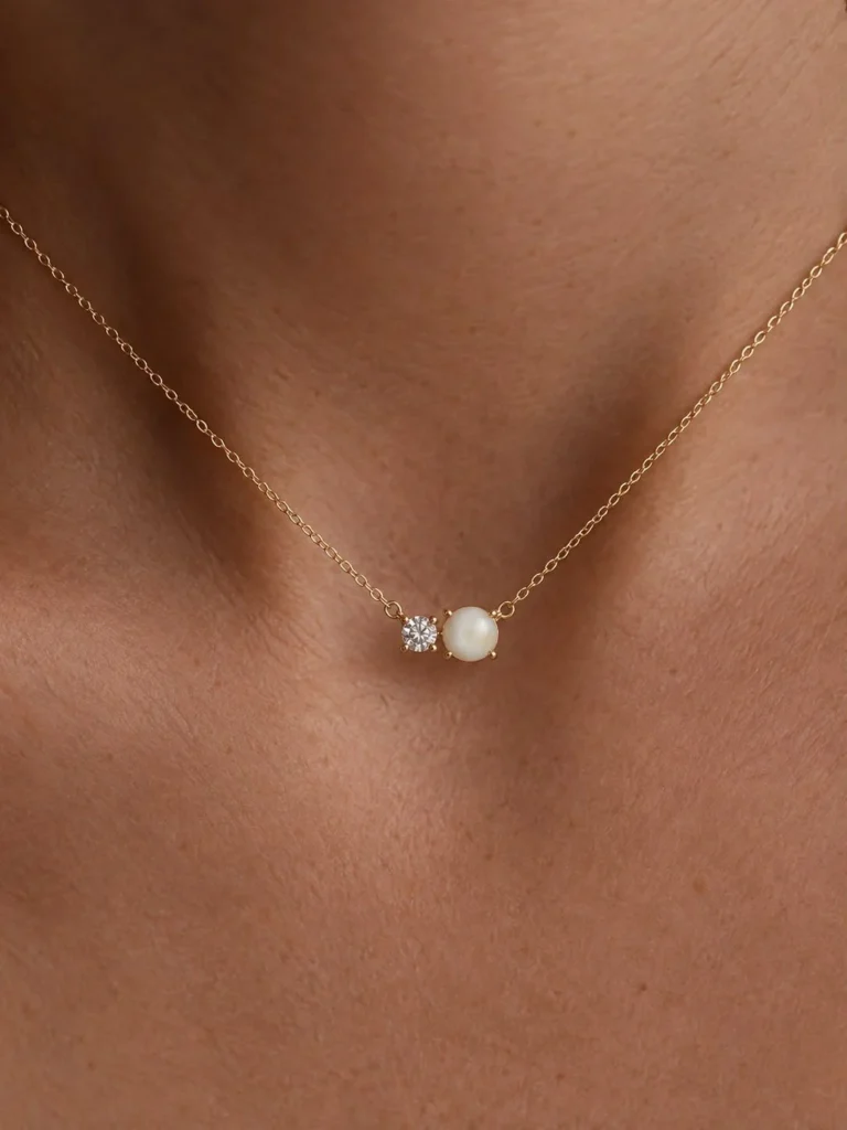 Breast milk keepsake necklace with a round milk stone beside a diamond on a fine gold chain, worn