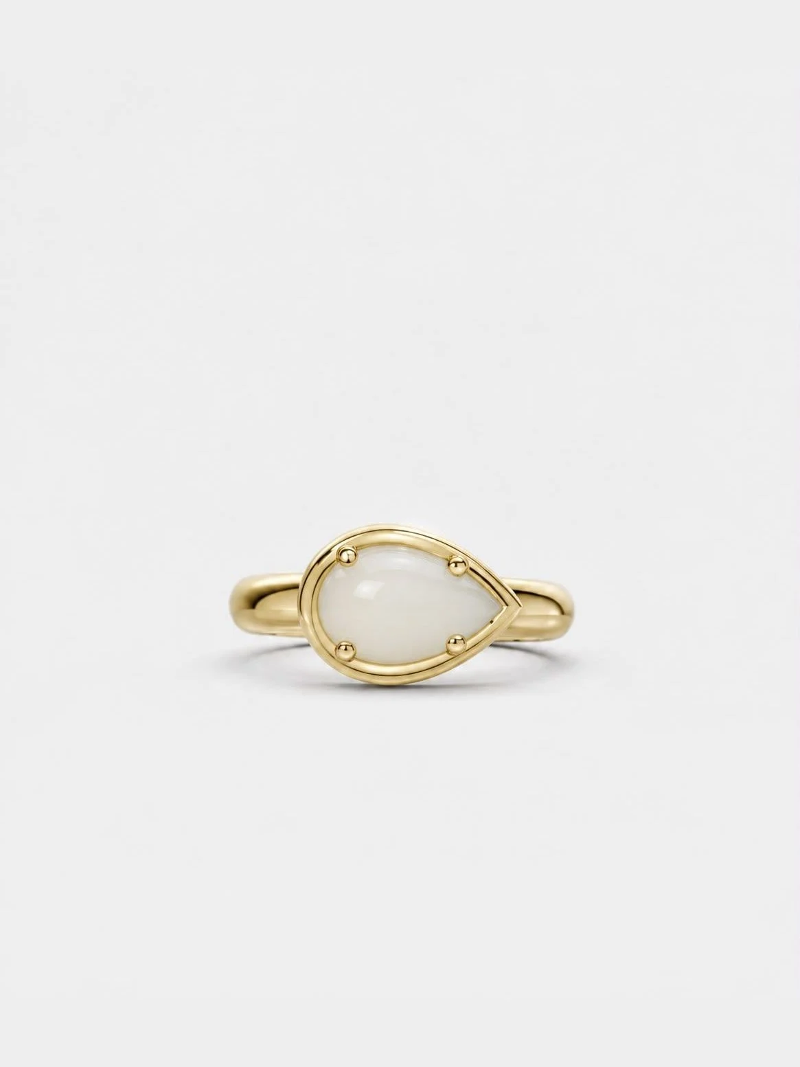 Breast milk keepsake ring with a pear-shaped milk stone set sideways in yellow gold