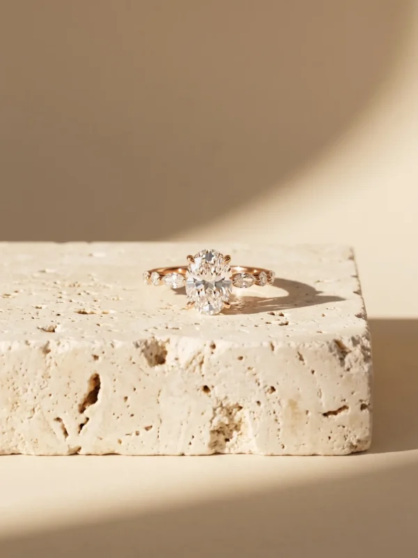 Oval diamond solitaire ring with marquise and round accent stones on the band